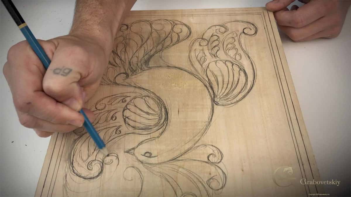 Blue pencil drawing the scrollwork straight onto an uncarved pale panel
