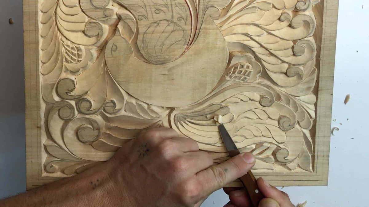 Hatched ground around carved plumage