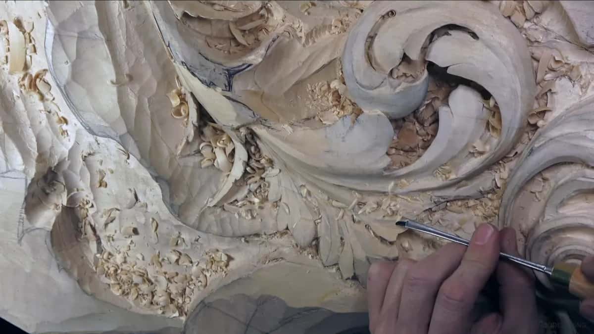One hand draws a long gouge across the bottom lobe.