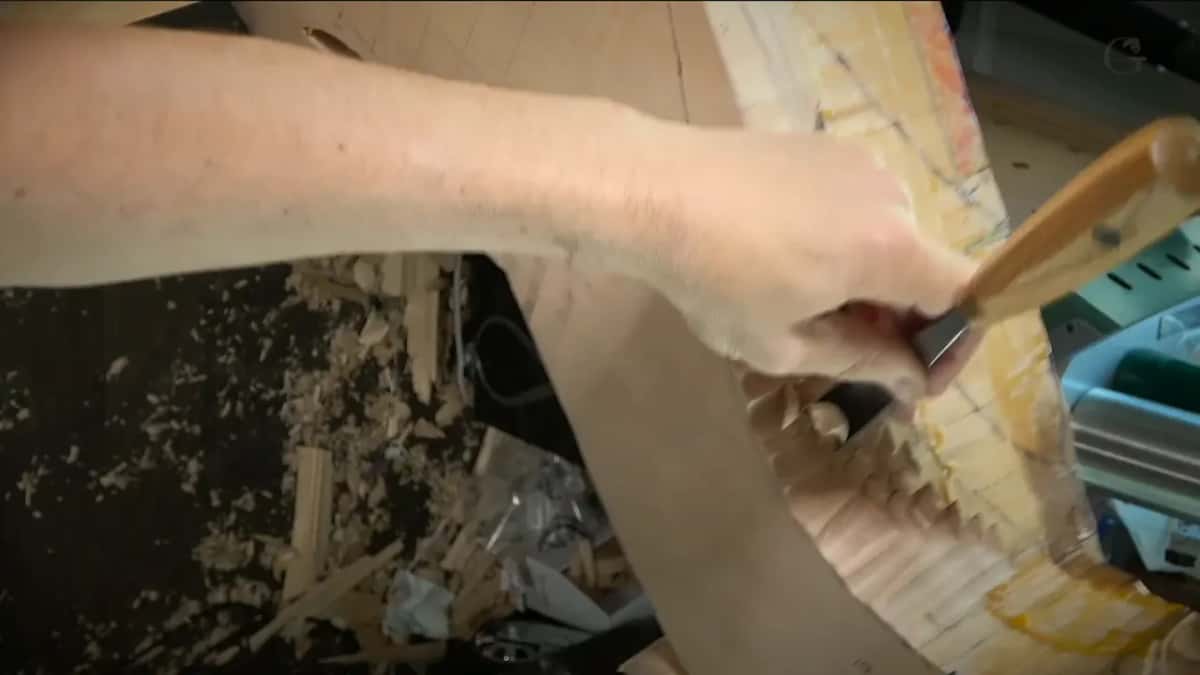 From above, a gouge goes in at a slant along the side while chips cover the floor below