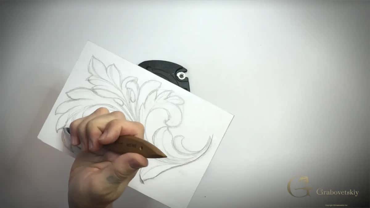 Nothing on the board but a knife and the drawing, the oldest way there is of working an ornament