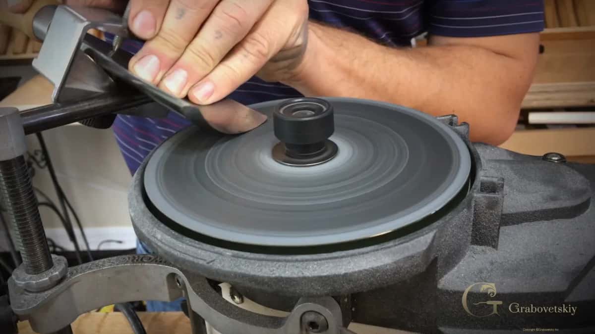 Riding the jig across the grey polishing disc at speed.