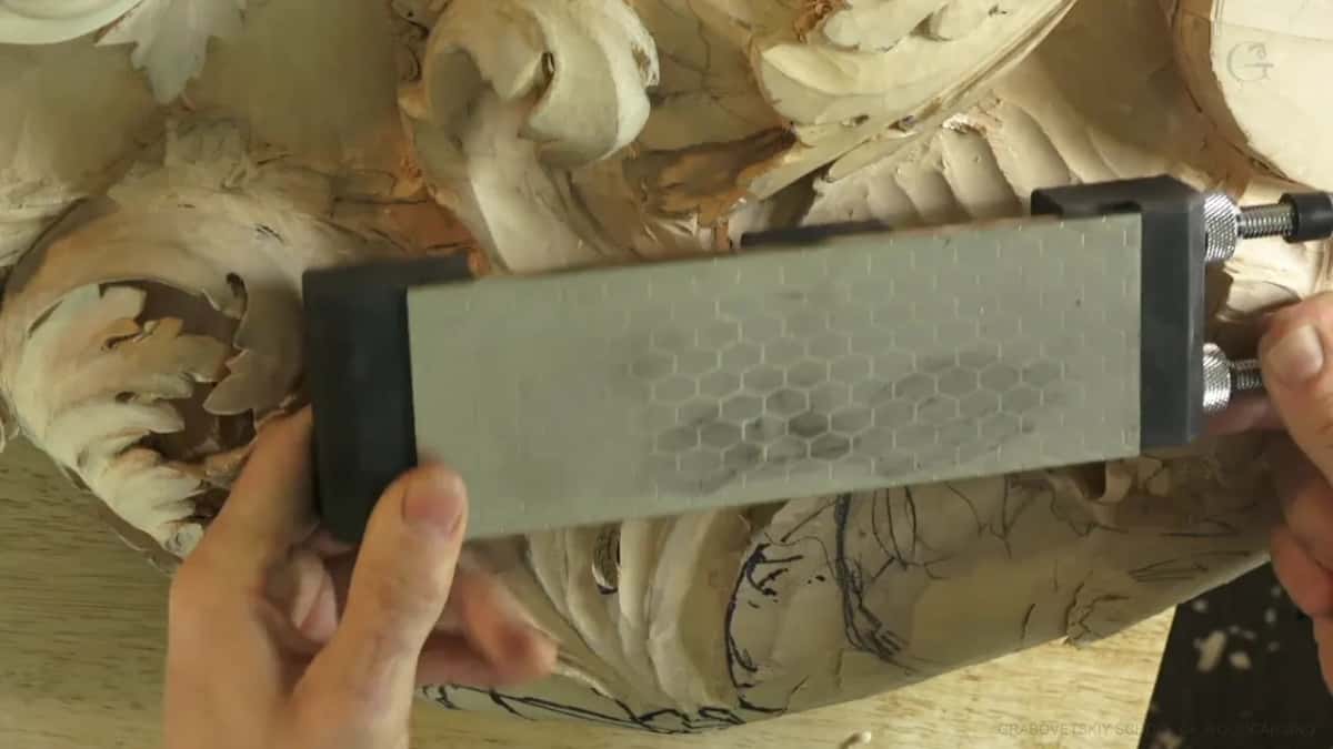 Diamond plate in a holder, its hexagon pattern catching the light.