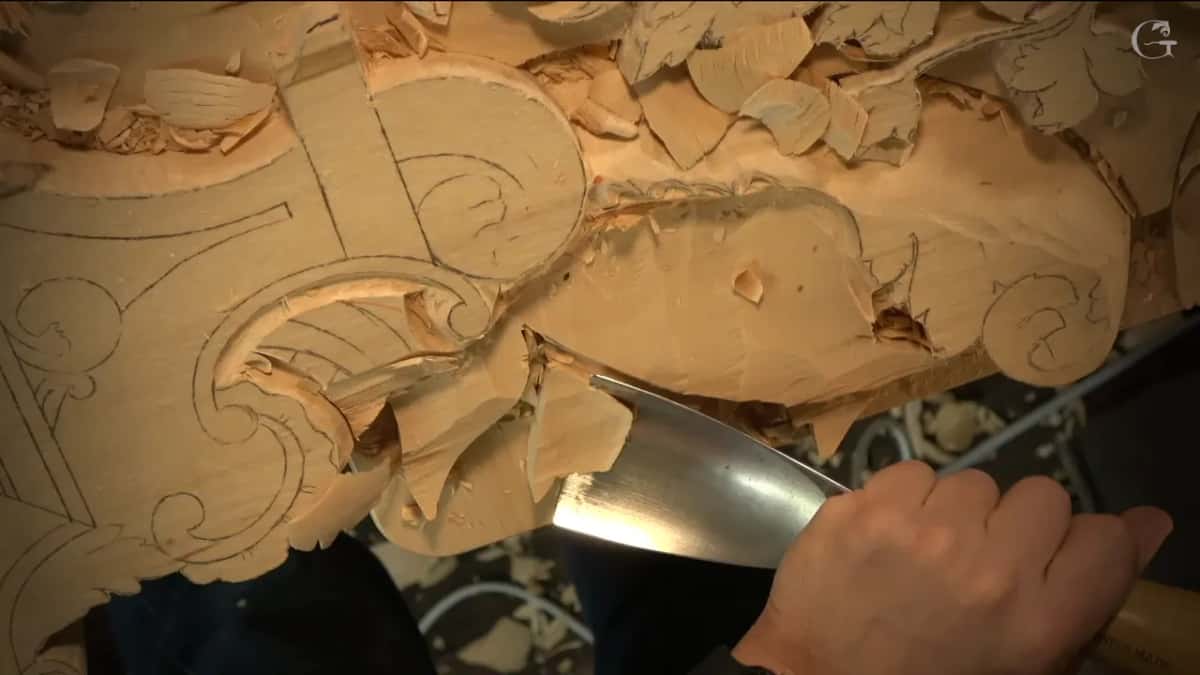 Big curved blade biting in next to a leaf shape
