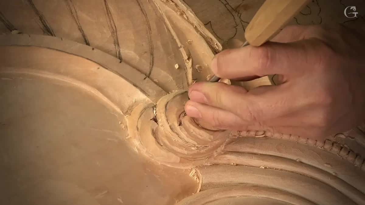 Thumb pressed down beside the spiral
