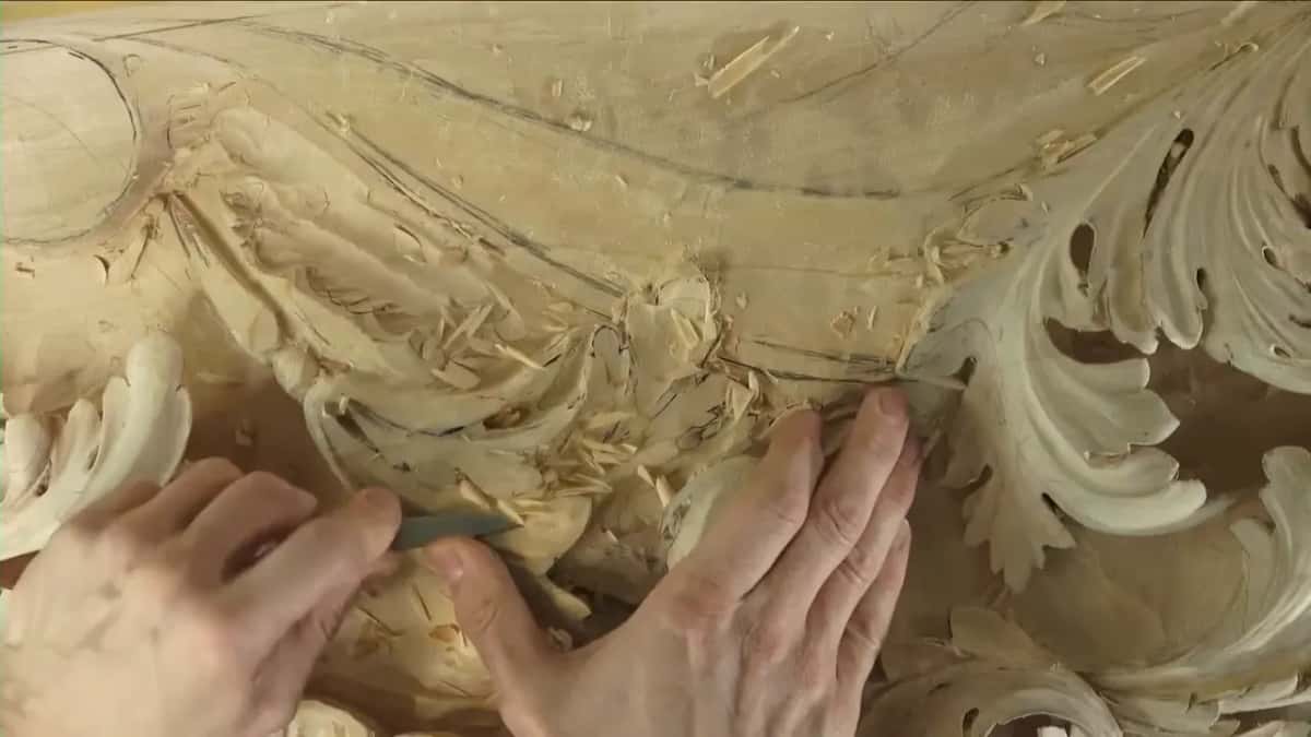 Thumb steadying the blade on the panel