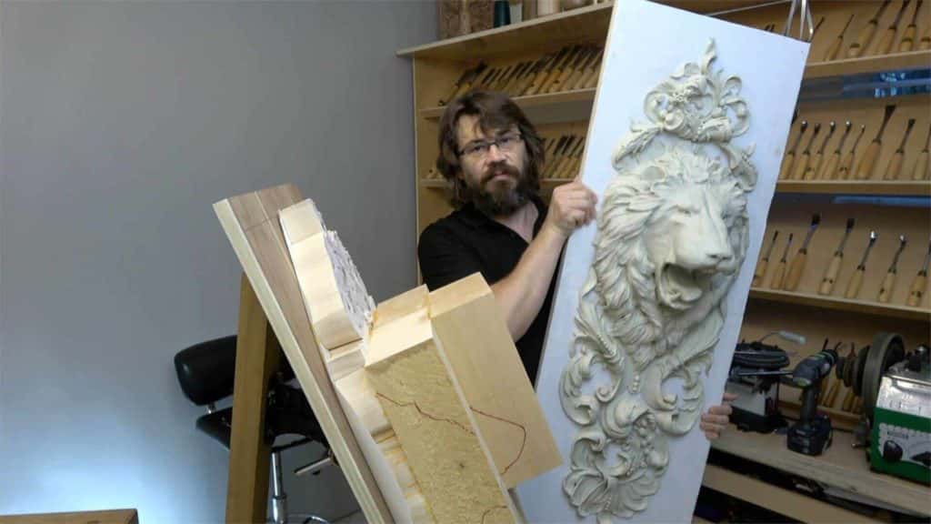 First lion head onlay of a mirrored pair carved in wood