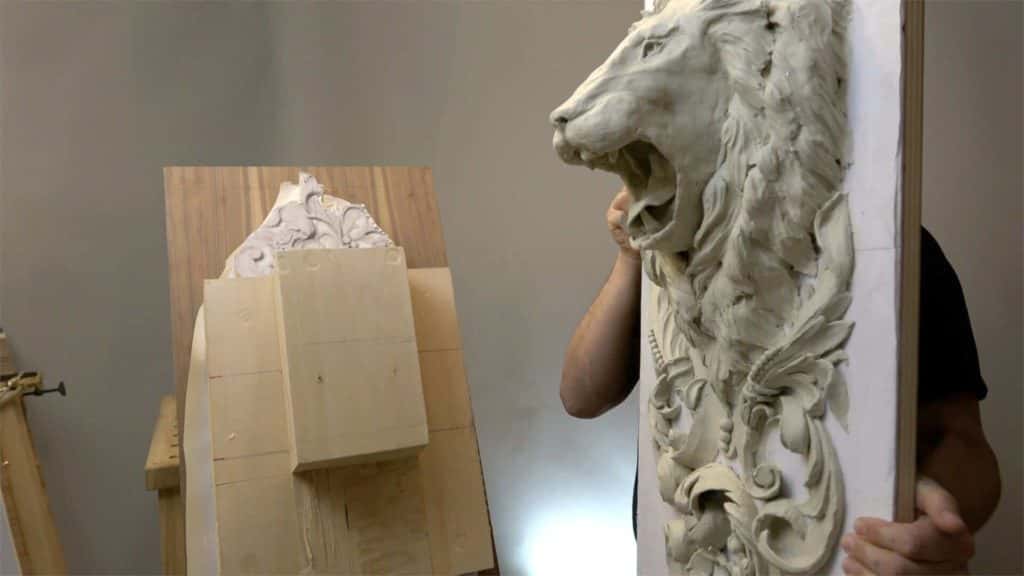 Second lion head onlay carved as the mirror of the first