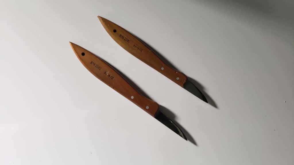 Two Swiss made chip carving knives laid side by side, the only wood carving tools a beginner needs