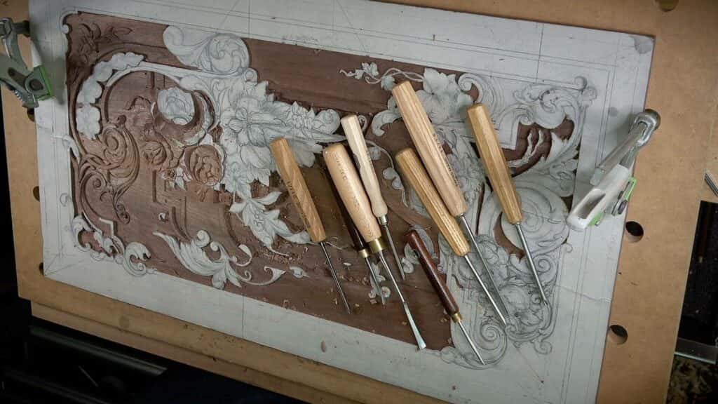 Shallow carved ornament on a furniture panel, the depth most beginner relief work actually needs