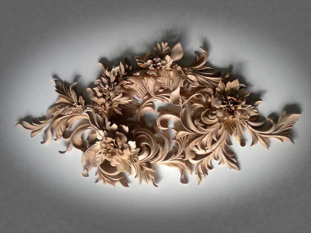 A beautiful wood carving featuring intricate floral designs, perfect for showcasing the artistry found in wood carving classes and lessons. This detailed piece highlights the skill involved in creating stunning wooden art.