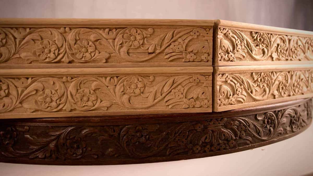 Carved oak moldings with running floral scrollwork, the kind of repeating ornament gouges are made for