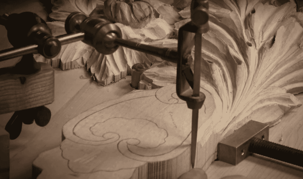 Pointing machine clamped over a detailed relief carving in progress