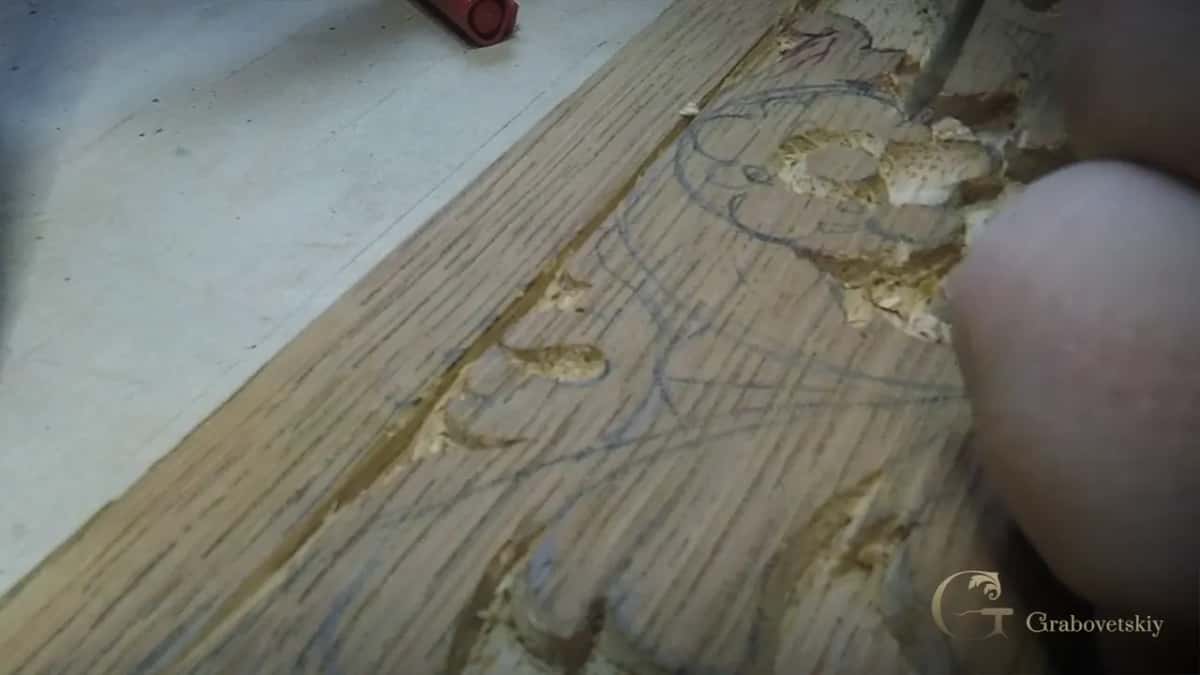 Open coarse grain, pale flakes torn up along a pencil scroll.
