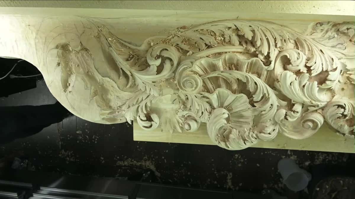 A wide basswood panel carved with a Baroque acanthus and shell frieze, seen from above