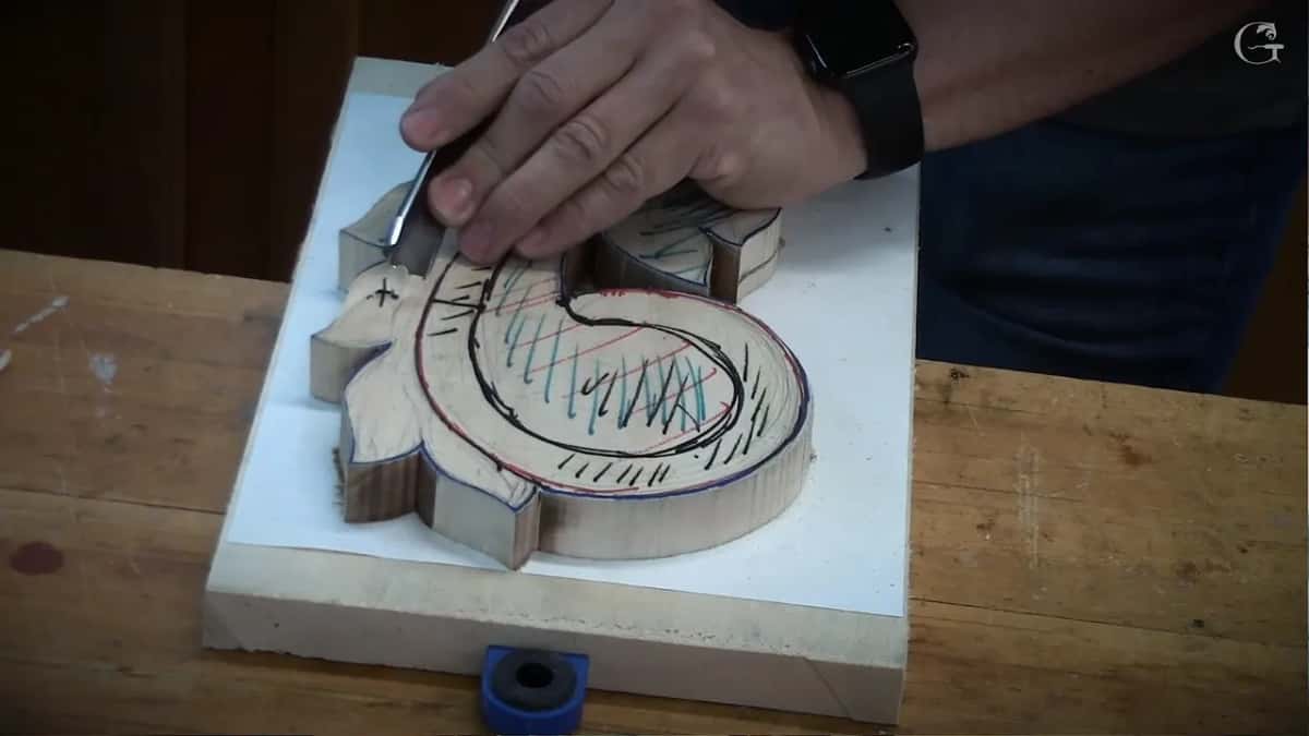 A gouge rotated through the pass so its edge shears the fibers, my second hand riding near the blade