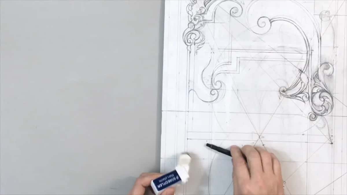 An eraser in one hand, redrawing a leaf tip so it stops short of the line instead of touching