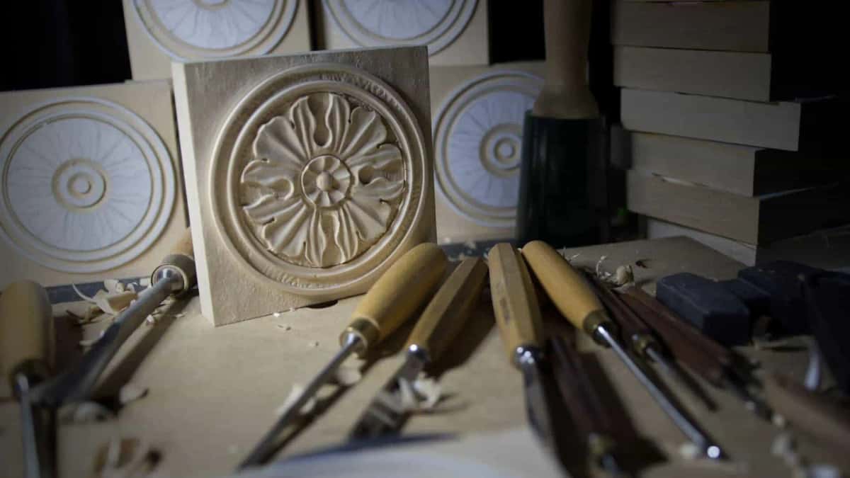 Carved rosette corner blocks standing on the bench beside a mallet