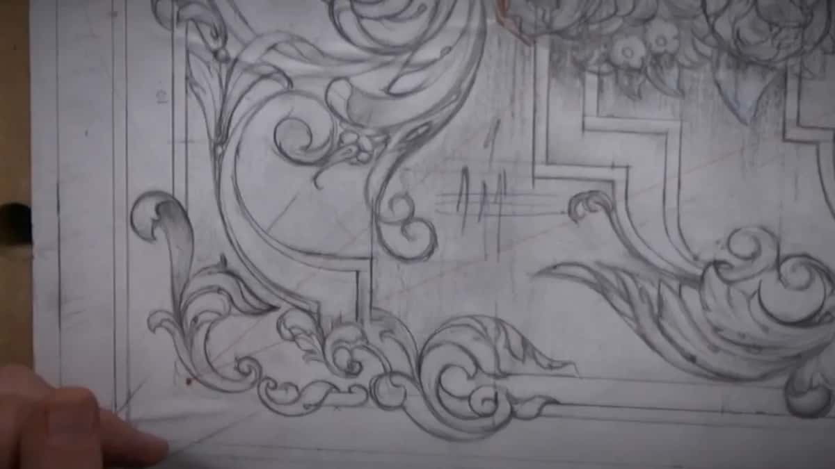 The whole design drawn out in pencil first, ground shading and every leaf, before a tool touches the board