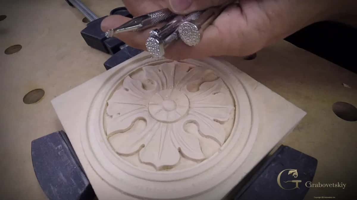 Three leather punches held over a finished rosette