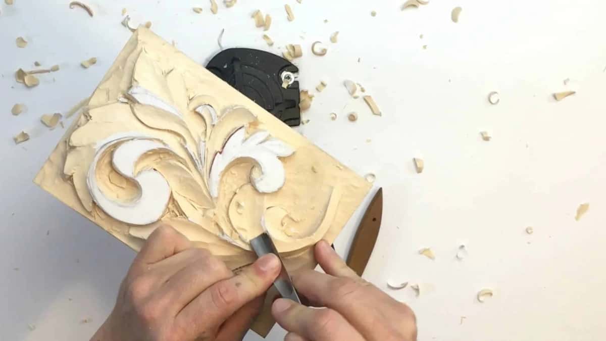 Working around the curl Gouge working around the tight curl of a Greek acanthus, board clamped low