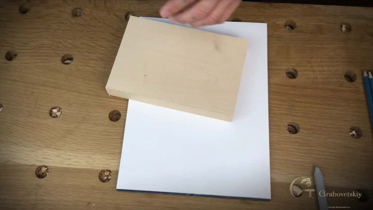 A planed basswood block on a paper pad