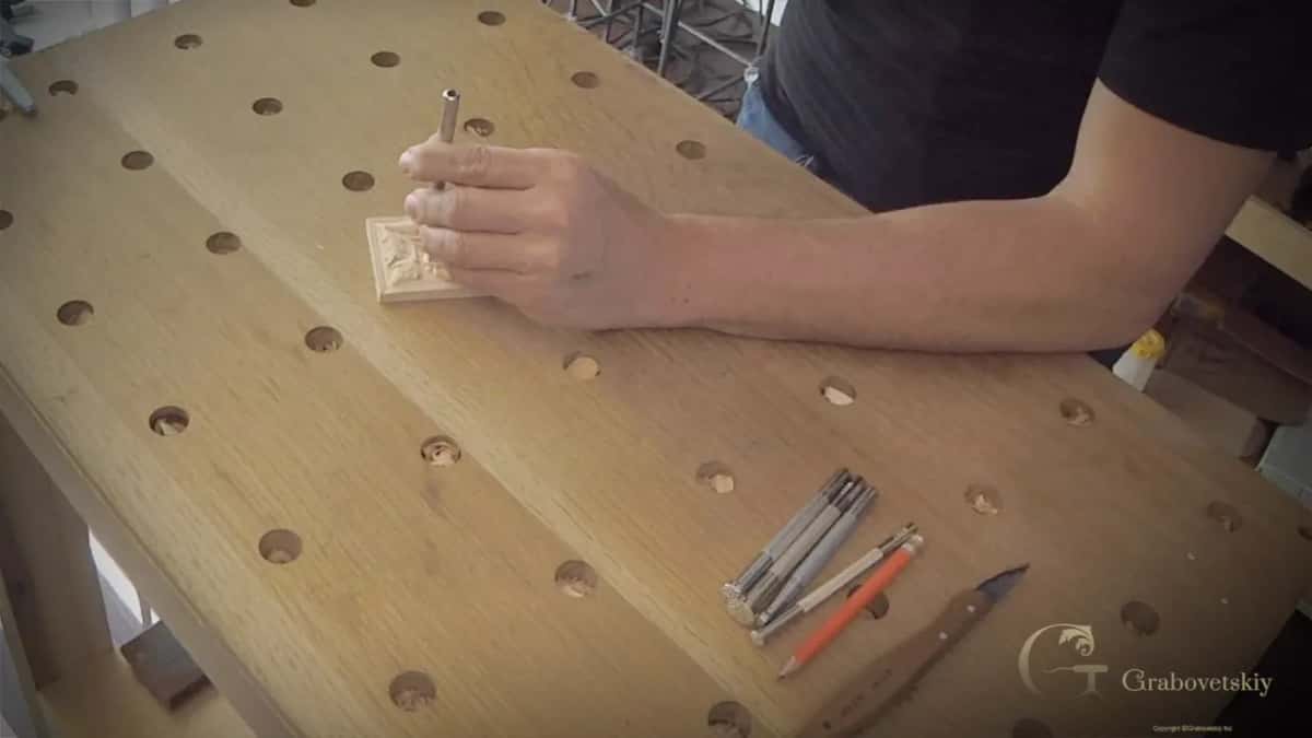 Punching the background Leather punch upright on a rosette