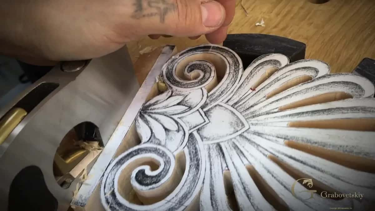 Palmette base being planed Deep spirals on a carved palmette