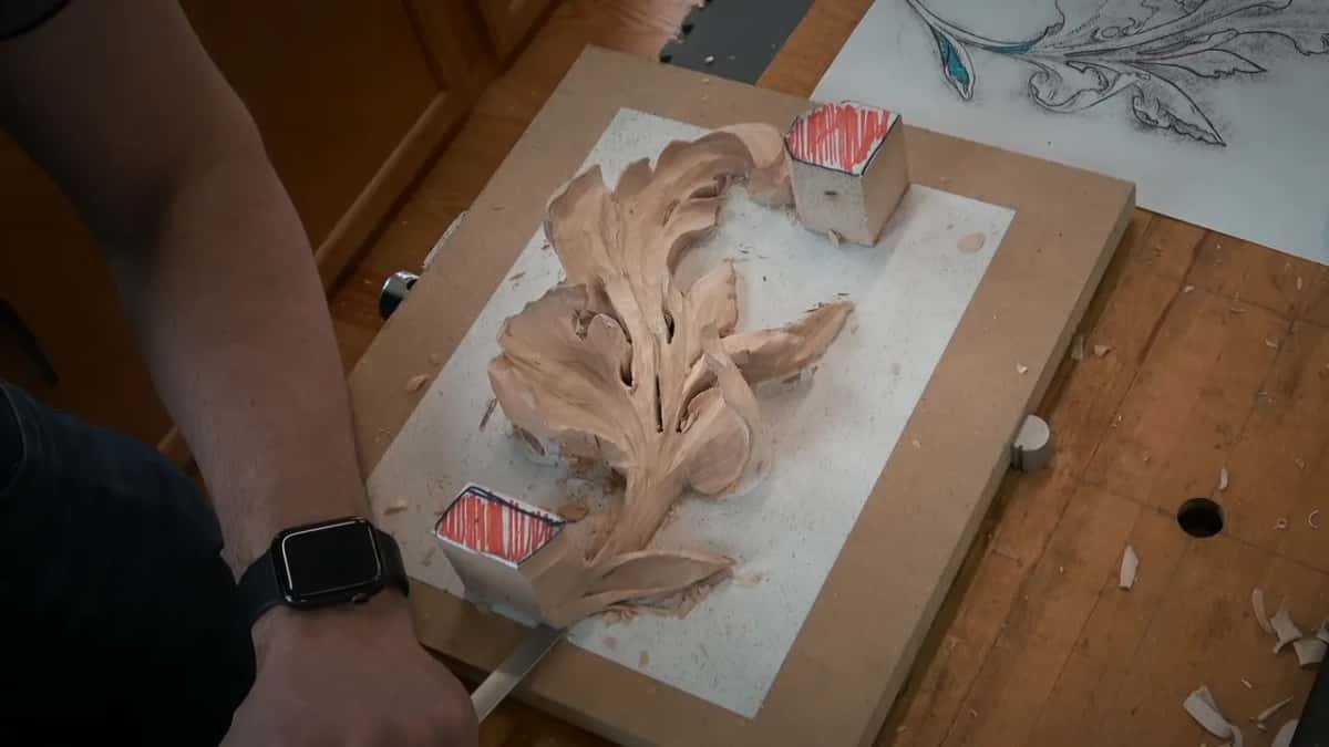 Freeing the carving Flat gouge working in low to free the finished acanthus from the board it grew on