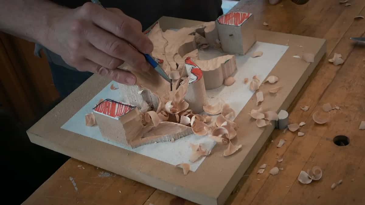 Redrawing on a roughed out acanthus Red pencil putting lines back on a roughed leaf, chips lying where they fell