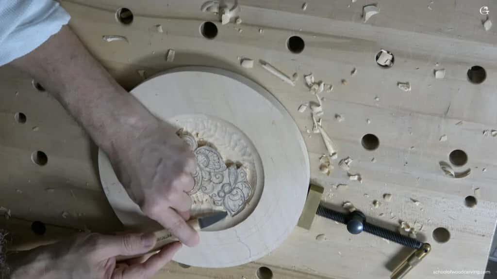 Working the centre of the butterfly plate, the blank held down on a bench with dog holes