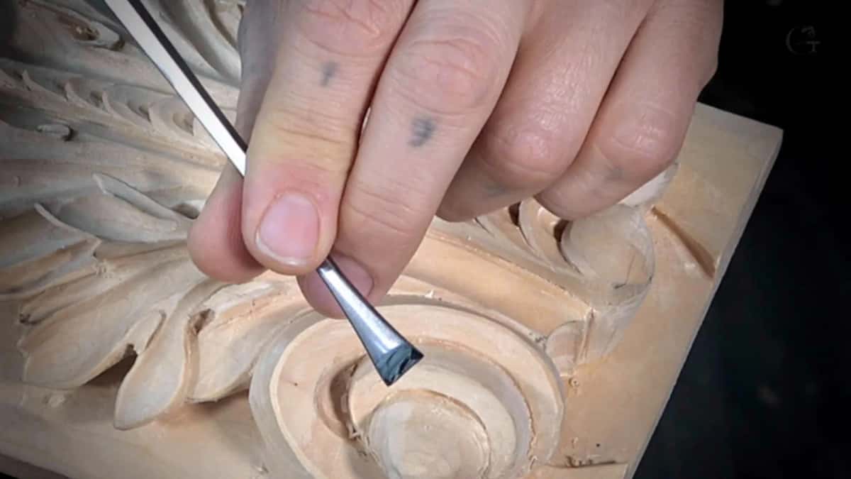 Cutting the eye of the volute Small gouge held almost flat, cutting the round eye at the centre of a volute