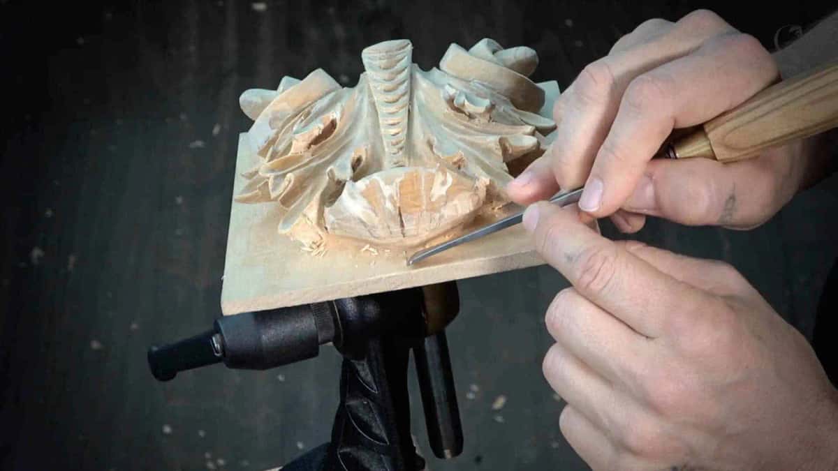 Cleaning the top rows Both hands cleaning the edges along the top rows with a narrow tool