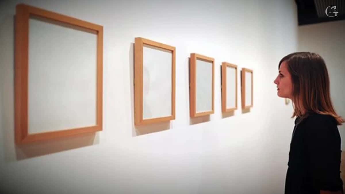 Empty frames in a modern gallery Five empty frames, one visitor