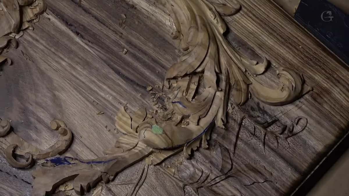 A flower roughed out of heavily figured olive, blue and green pattern marks left on the carved petals.