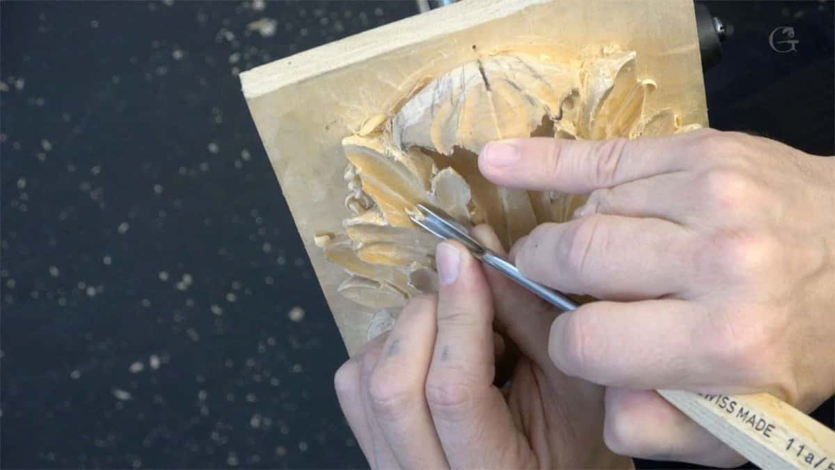 A Swiss made Pfeil gouge guided across a carved panel