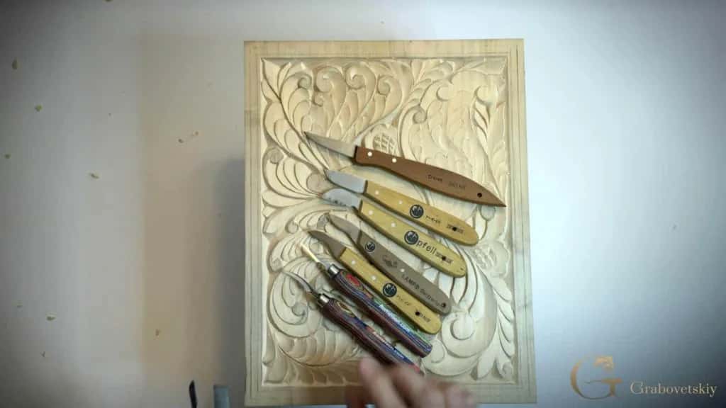 The finished board with the knives that cut it lying across the face