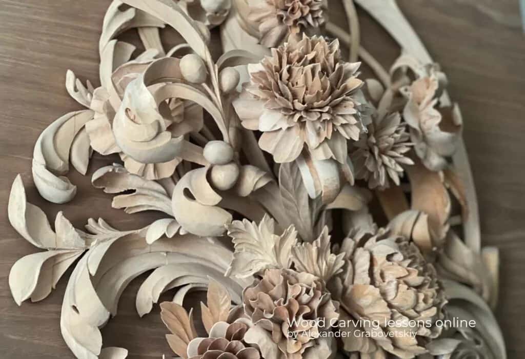 A large floral carving cut deep enough that the top blooms throw shadow onto the ones behind