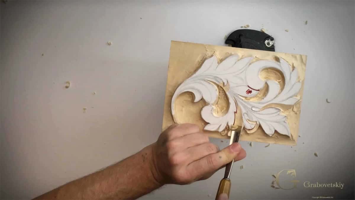 Marking the eye in red Red pencil mark on a carved leaf