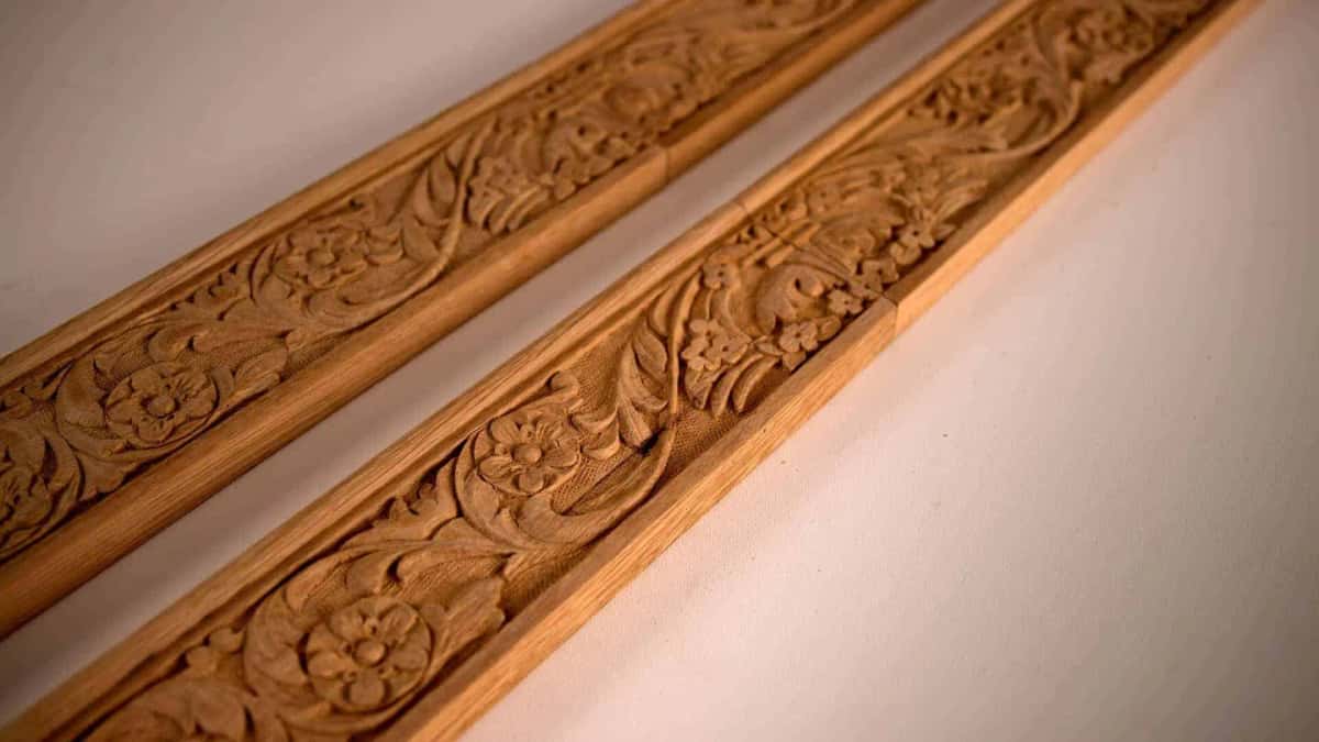 Two carved apron lengths lying side by side, ornament and punched ground matched between them
