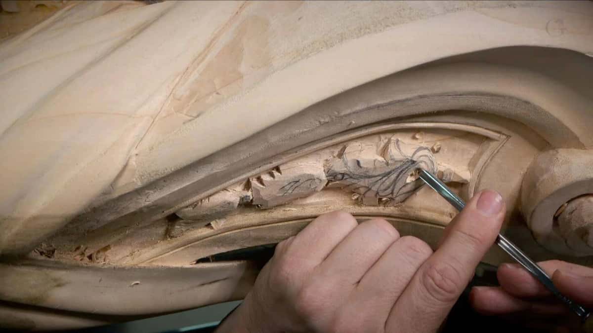 Carving along the long curve of the Venice room panel, the tool riding right in the hollow