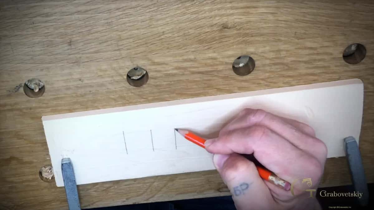 Division lines marked straight onto the board by hand, with no ruler anywhere near it