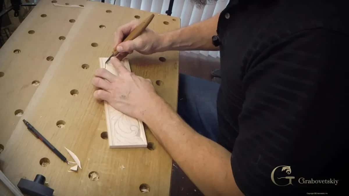 Keeping the steadying hand behind the edge Steadying hand kept well behind the blade on a basswood molding
