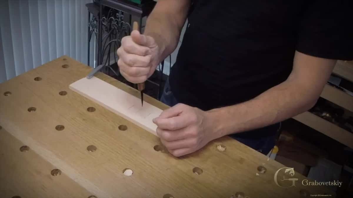 Blade driven straight down at 90 degrees into the clamped practice board