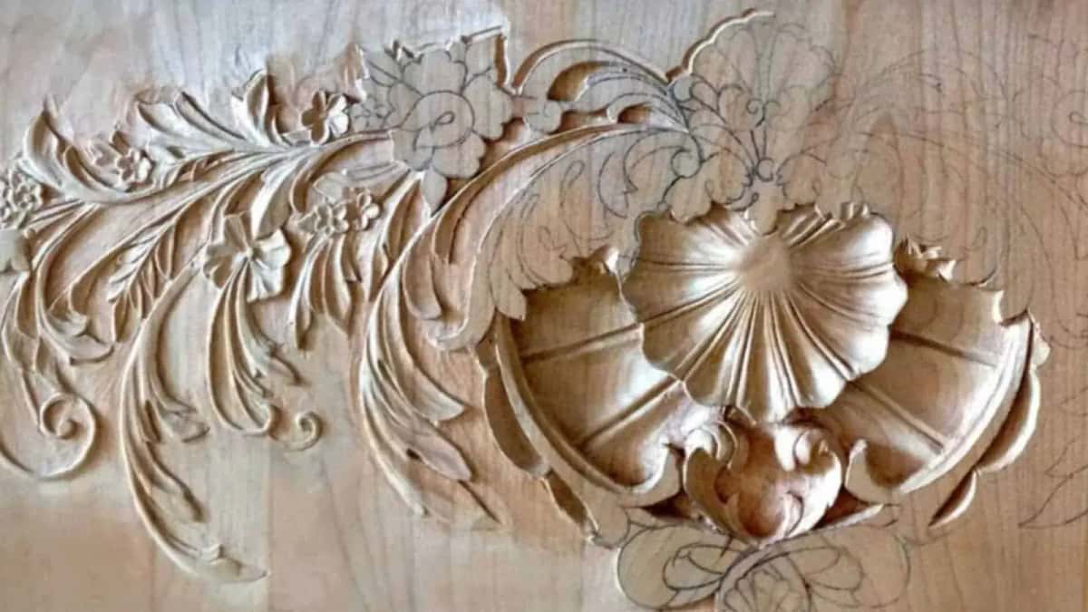 A low relief carving of a shell and acanthus leaves, one half finished and the other half still only pencil on the wood