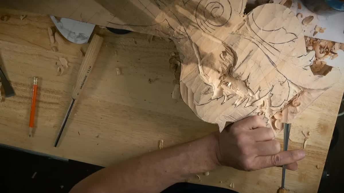 Gouge held upright at the lower edge of the carving
