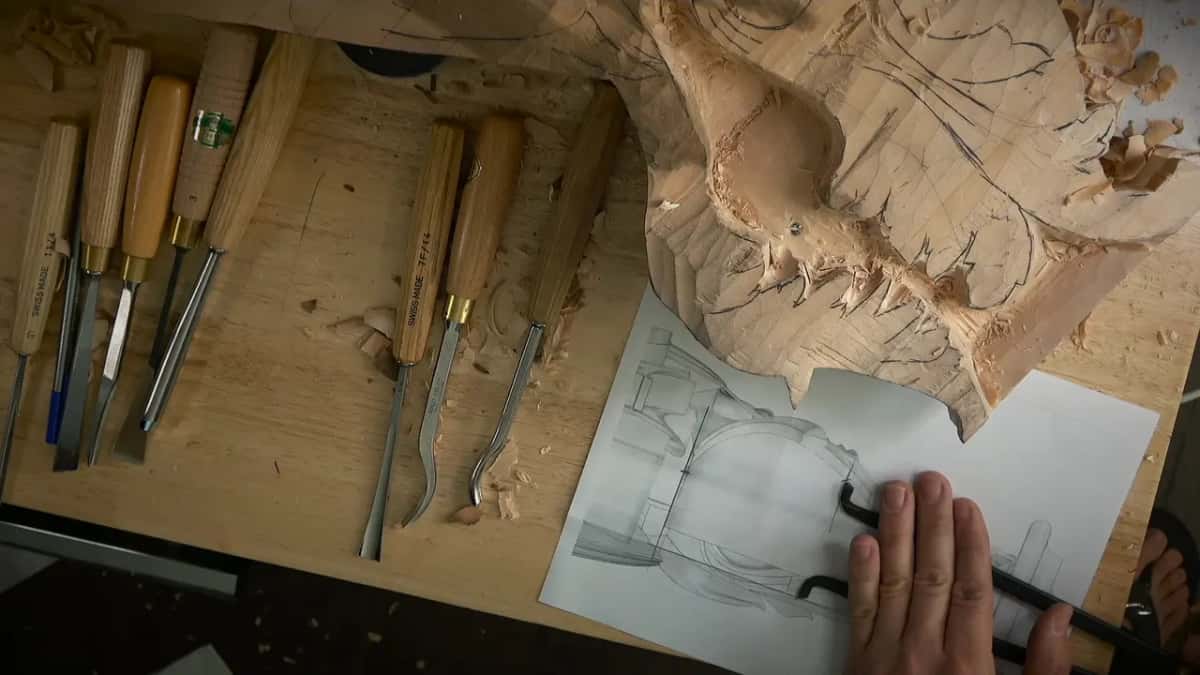 A printed side view on the bench, one hand resting on it