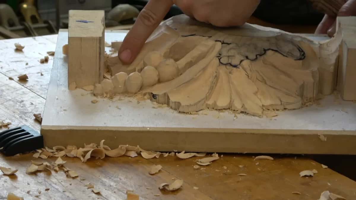 Finger pointing out the depth beside the row of beads
