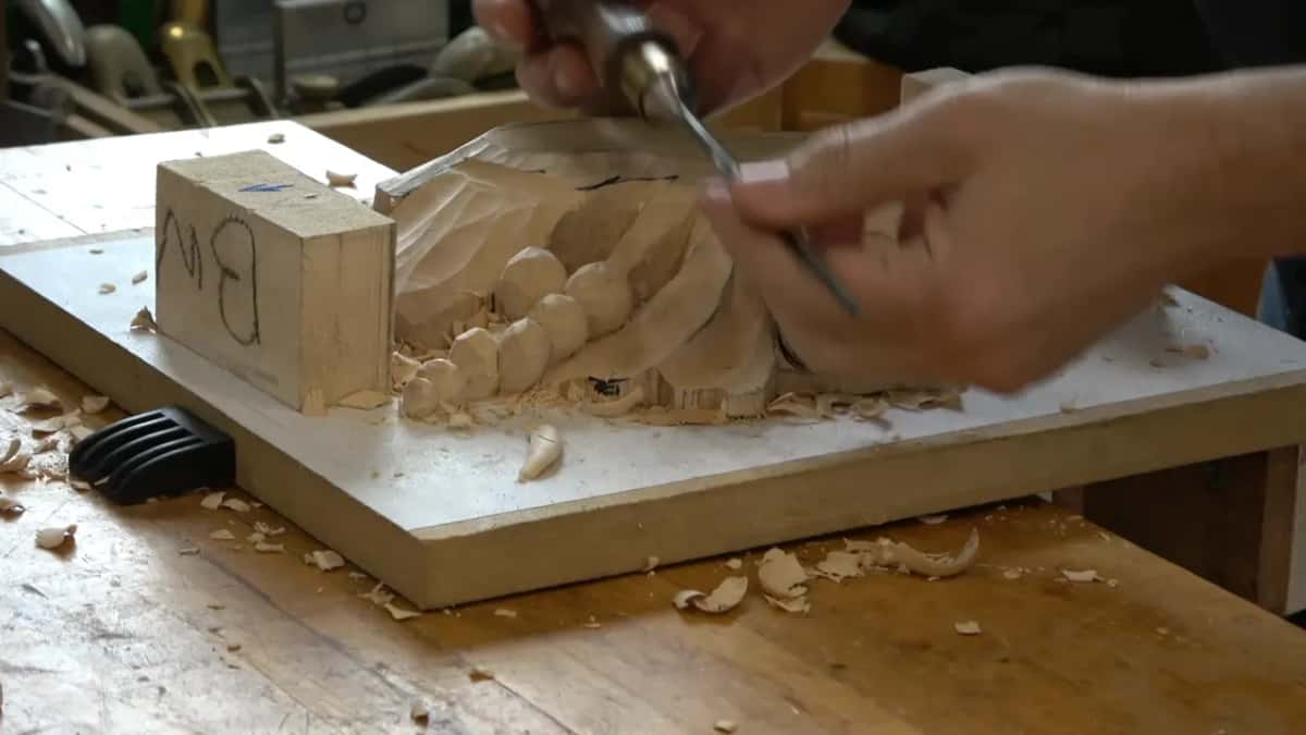 Brass ferruled gouge working in beside the row of carved beads