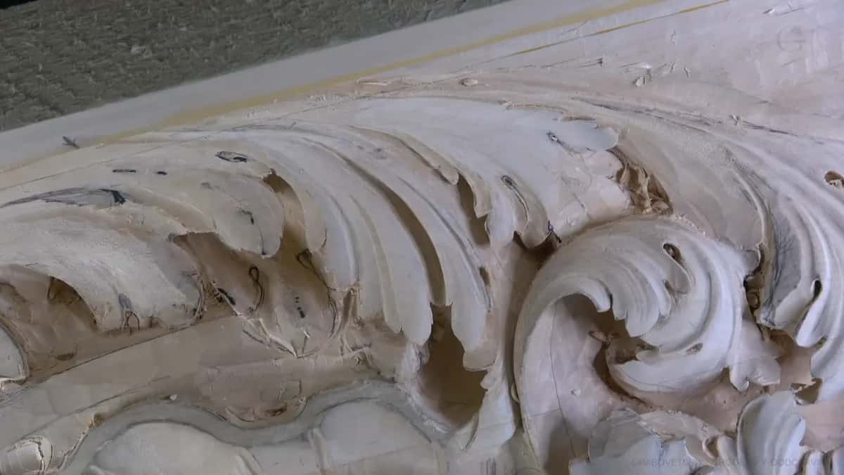 Carved acanthus curls, no hands.